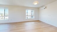 This contemporary apartment, situated at 900 Chestnut St in Redwood City, offers a well-designed living space of 790 square feet. The unit features two bedrooms, including a primary bedroom of 150 square feet, and one bathroom. The open-concept layout seamlessly combines the kitchen and living room, creating a spacious and fluid environment.

Throughout the apartment, large windows flood the rooms with natural light, offering views of the surrounding area and enhancing the sense of spaciousness. The modern kitchen is equipped with stainless steel appliances and sleek wooden cabinetry, complementing the overall design aesthetic.

All rooms boast high-quality hardwood flooring, adding warmth and elegance to the space. The bathroom features a combination tub and shower, with ample storage provided by a wooden vanity. Climate control is ensured through the presence of air conditioning units.

The apartment's neutral color palette, dominated by white walls, creates a blank canvas for personal styling. Built-in closets in the bedrooms and sliding doors maximize space efficiency. This well-appointed apartment combines functionality with contemporary design, offering a comfortable urban living experience in the heart of Redwood City.