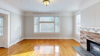 Located at 206 Tacoma Ave S in the heart of Tacoma, WA, this two-bedroom, one-bathroom home offers a thoughtfully laid-out single floor with generous living space and timeless architectural character throughout. Warm, gleaming hardwood floors flow seamlessly through every room, anchoring the home's classic aesthetic.

The inviting living room is bathed in natural light from large windows and features crown molding and a ceiling fan. Adjacent, the bay-windowed dining room showcases elegant wainscoting, crown molding, and a vintage pendant light fixture, creating a refined yet welcoming atmosphere. The kitchen is well-appointed with white cabinetry, dark countertops, a gas range, and ample natural light from multiple windows, complemented by track lighting overhead.

A standout feature of the home is the built-in hutch in the dining area — a charming period detail complete with open shelving, lower cabinetry, and decorative tiled countertop. The two bedrooms are comfortably sized, each with hardwood floors, ceiling fans, and windows providing natural light. The bathroom retains its vintage charm with a classic clawfoot soaking tub, beadboard wainscoting, and a white vanity. Four hallways connect the rooms efficiently, and a dedicated closet provides additional storage.