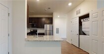 Located at 23 Clearview Dr in Ocean, NJ, this single-floor residence offers a thoughtfully designed layout with a clean, contemporary aesthetic throughout. The kitchen serves as a functional centerpiece, featuring dark espresso cabinetry, granite countertops, a stainless steel sink, and a full suite of stainless steel appliances including a gas range, microwave, and refrigerator. Light wood-tone flooring runs through the kitchen and common areas, lending warmth and continuity. A peninsula with a granite overhang provides additional workspace and a natural transition into the adjoining living area.

The bedrooms are finished with plush wall-to-wall carpeting and neutral tones, creating a comfortable, quiet atmosphere. Each bedroom includes its own closet, and windows allow natural light to brighten the spaces. The primary bedroom connects directly to an en-suite bathroom featuring large-format tile walls, a glass-enclosed walk-in shower, a dark vanity with a white countertop, and tile flooring. A second full bathroom offers a soaking tub with tiled surround, a matching dark vanity, and coordinating tile floors. The overall design is cohesive, emphasizing practical finishes and a move-in-ready condition throughout.
