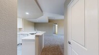 Located at 805 Regulo Place in Chula Vista, CA, this single-floor, 5-bedroom, 3-bathroom home offers a well-designed layout with a range of functional and comfortable spaces throughout. The open-concept living room is a standout feature, boasting soaring vaulted ceilings with a ceiling fan, soft carpeted flooring, and a clean-faced fireplace. A sliding glass door leads to a balcony with views of the surrounding neighborhood and hills, filling the space with natural light. The kitchen is efficiently arranged with white cabinetry, light countertops, a full suite of appliances including a range, built-in microwave, dishwasher, and refrigerator, plus light wood-style flooring. A peninsula bar connects the kitchen to the living area, enhancing the open flow. The five bedrooms are carpeted and feature neutral-toned walls, with at least one room including mirrored sliding closet doors and a ceiling fan with a window offering natural light. The bathrooms are finished with white vanities, light wood-style flooring, and tub-shower combinations, with windows allowing in natural light. A dedicated closet and hallway complete the interior layout, making this home both practical and comfortable.