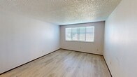 Located in Tacoma, WA, this 2-bedroom, 2-bathroom unit offers a practical and well-organized single-floor layout. Light wood-style laminate flooring runs consistently throughout the living areas and bedrooms, complemented by neutral-toned walls and textured popcorn ceilings that lend a classic character to the interior.

The spacious primary bedroom is a standout feature, offering generous room for furnishings and a large window fitted with blinds that allows ample natural light to fill the space while providing a view of the surrounding neighborhood. The second bedroom is cozy and well-proportioned, also featuring the same light flooring and a ceiling-mounted light fixture.

The living area benefits from natural light through a window with blinds and includes a wall-mounted heating unit, ensuring year-round comfort. A dedicated closet provides convenient storage within the unit.

Both bathrooms are functional and clean in design. One bathroom features a full tub-shower combination with a white surround, chrome fixtures, and a small window above the tub that introduces additional natural light. The bathrooms are finished with tile flooring and standard fixtures.

Overall, this unit presents a straightforward, move-in-ready layout with consistent finishes throughout, making it a practical choice for those seeking a manageable, comfortable living space in Tacoma.