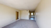 Located at 6869 Enid Ct in the west El Paso community of 79912, this single-story, 2-bedroom, 2-bathroom home offers a functional and straightforward layout. The living room features neutral-toned carpet and a textured ceiling, with an open sightline connecting to the dining area and kitchen, which transition to tile flooring. The combined dining room and kitchen area provides convenient access to the rest of the home via a central hallway.

Both bedrooms are carpeted and receive generous natural light through wide, multi-pane windows. Each bedroom is equipped with a ceiling fan and has access to a closet with built-in shelving and hanging rods, offering practical storage. The primary bedroom is a comfortable size with its own closet and an adjacent bathroom. The second bedroom similarly benefits from bright natural light and a ceiling fan.

The two bathrooms feature tile flooring, with at least one including a full tub-shower combination. Throughout the home, the color palette remains light and neutral, with cream-colored walls that enhance the brightness of each room. Four closets distributed across the floor plan ensure ample storage. The overall layout is efficient and well-connected, making this home a practical option in a residential El Paso neighborhood.