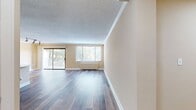 This contemporary apartment, known as The Whitmore Two Bedroom B1.5A 520, offers a spacious 920 square feet of living area on a single floor. The layout comprises two bedrooms, two bathrooms, and an open-concept kitchen and living room. The primary bedroom is generously sized at 200 square feet, providing ample space for comfort and relaxation.

Throughout the apartment, modern hardwood flooring adds warmth and elegance to each room. The kitchen showcases a sleek design with updated cabinetry, quartz countertops, and stainless steel appliances. Its galley-style layout maximizes efficiency while maintaining an open feel to the adjacent living area.

Large windows in the living room and bedrooms allow for abundant natural light, creating a bright and airy atmosphere. A sliding glass door leads to a private balcony, offering picturesque views of the surrounding cityscape and greenery.

The bathrooms feature modern fixtures and finishes, including tiled walls and contemporary vanities. The apartment also includes ample closet space and in-unit laundry facilities for added convenience.

Ceiling fans in the bedrooms provide additional comfort and air circulation. The neutral color palette throughout the apartment allows for versatile decorating options, making it easy for residents to personalize their living space.