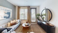 This well-appointed one-bedroom, one-bathroom residence in Atlanta, GA offers a thoughtfully designed layout across a single floor, making efficient use of every square foot. The open-concept kitchen is a standout feature, showcasing two-tone cabinetry with warm wood lower cabinets and crisp white upper cabinets, white quartz countertops, a subway tile backsplash, and a full suite of stainless steel appliances including a refrigerator, range, microwave, and dishwasher. A central kitchen island provides additional prep space and casual seating. The living room is bright and inviting, with large windows and a glass door that opens to a private balcony, filling the space with natural light and outdoor views. A textured accent wall adds depth and character to the living area. The bedroom is a comfortable retreat, featuring a ceiling fan, natural light from a generous window, and direct access to a dedicated closet. The bathroom is finished with large-format marble-look tile surrounding the soaking tub and shower, a wood-grain vanity with a white countertop, and recessed lighting. Light wood-style flooring runs throughout the main living areas, tying the space together with a warm, modern aesthetic.