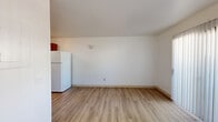 Located on Camino Del Norte in Sierra Vista, Arizona, this two-bedroom, one-bathroom residence offers a practical and well-organized single-floor layout. Light wood-style flooring runs throughout the entire space, lending a cohesive and clean look to every room.

The kitchen is efficiently designed in a galley style, featuring warm wood cabinetry on both sides, light marble-style countertops with a double-basin sink, and white appliances including a refrigerator and range. A closet with bi-fold doors provides additional storage directly adjacent to the kitchen area.

The living area is open and simply appointed, with white walls that maximize the sense of light and space. Natural light filters in through windows fitted with horizontal blinds, creating a bright and airy atmosphere.

Both bedrooms offer a quiet, neutral environment with the same wood-style flooring and windows that allow in natural light. The primary bedroom includes a closet, while the second bedroom also benefits from a window with natural light and direct access to the main living area.

The bathroom is clean and functional, featuring a full tub-shower combination with white tile surround, a white vanity with under-cabinet storage and a mirror above, and the same wood-style flooring that ties the space together. The overall ambiance is understated, tidy, and move-in ready.