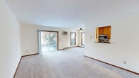 This well-designed apartment offers 780 square feet of living space on a single floor, featuring two bedrooms and one bathroom. The heart of the home is the updated kitchen, showcasing granite countertops, wooden cabinetry, and stainless steel appliances including a refrigerator, stove, and built-in microwave. The galley-style layout maximizes efficiency while providing ample storage and workspace.

The primary bedroom, measuring 170 square feet, offers generous space and includes a large window for natural light. Both bedrooms feature plush carpeting and built-in closets for storage. The bathroom is equipped with a vanity featuring a granite countertop, matching the kitchen's aesthetic, and includes a combined shower and bathtub.

A notable feature is the in-unit laundry facility, adding convenience to daily living. The living area is spacious and bright, with large windows and sliding glass doors leading to an outdoor space. Throughout the apartment, neutral tones and carpeting create a warm, inviting atmosphere. The property's layout is thoughtfully designed, ensuring a comfortable and functional living environment.