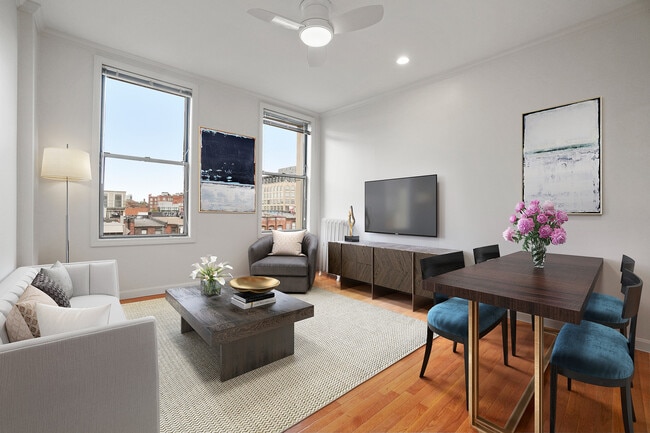 Bright, modern living and dining area featuring stylish furniture and vibrant decor, with large windows offering city views. - Atrio Boston