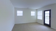 Located at 100 Reserve Ct in Grenville, NY, this single-floor residence offers a clean, move-in-ready layout with a light and airy aesthetic throughout. The interior is finished with neutral cream-toned walls that create a bright, welcoming atmosphere, complemented by wall-to-wall carpeting in a warm beige tone that adds comfort underfoot. Multiple windows fitted with white blinds allow generous natural light to fill the rooms, enhancing the open and spacious feel of the living areas. The design is characterized by its simplicity and functionality, with crisp white trim and baseboards providing a polished, cohesive look. The single-story layout offers convenient, step-free living, making the space easily accessible. The overall ambiance is calm and neutral, providing an ideal blank canvas for personalization. Situated in a residential community setting, the property at 100 Reserve Ct combines practical design with comfortable living in a straightforward, well-maintained environment.