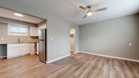 Located at 425 W Taft St in Wichita, Kansas, this efficiently designed single-floor studio offers a thoughtfully arranged layout that includes a living area, kitchen, closet, and full bathroom. The living area features warm, wood-look luxury vinyl plank flooring that runs throughout the space, neutral gray walls, crisp white trim, and a ceiling fan with integrated lighting — contributing to a clean, modern aesthetic. Natural light filters in through slatted window blinds, lending the space a bright and airy feel. A wall-mounted HVAC unit provides convenient climate control. The kitchen is outfitted with white shaker-style cabinetry, granite-look countertops, a stainless steel undermount sink with a pull-down faucet, and stainless steel appliances, including a refrigerator and range. A window above the sink allows for additional natural light. The bathroom continues the cohesive design with a white vanity cabinet, matching hardware, a window for ventilation, and hardwood-style flooring. A dedicated closet offers practical storage space. The textured ceiling adds a subtle architectural detail throughout. Overall, the space presents a functional and updated interior suited for efficient, comfortable living.