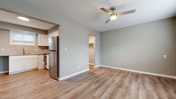 Located at 425 W Taft St in Wichita, Kansas, this efficiently designed single-floor studio offers a thoughtfully arranged layout that includes a living area, kitchen, closet, and full bathroom. The living area features warm, wood-look luxury vinyl plank flooring that runs throughout the space, neutral gray walls, crisp white trim, and a ceiling fan with integrated lighting — contributing to a clean, modern aesthetic. Natural light filters in through slatted window blinds, lending the space a bright and airy feel. A wall-mounted HVAC unit provides convenient climate control. The kitchen is outfitted with white shaker-style cabinetry, granite-look countertops, a stainless steel undermount sink with a pull-down faucet, and stainless steel appliances, including a refrigerator and range. A window above the sink allows for additional natural light. The bathroom continues the cohesive design with a white vanity cabinet, matching hardware, a window for ventilation, and hardwood-style flooring. A dedicated closet offers practical storage space. The textured ceiling adds a subtle architectural detail throughout. Overall, the space presents a functional and updated interior suited for efficient, comfortable living.