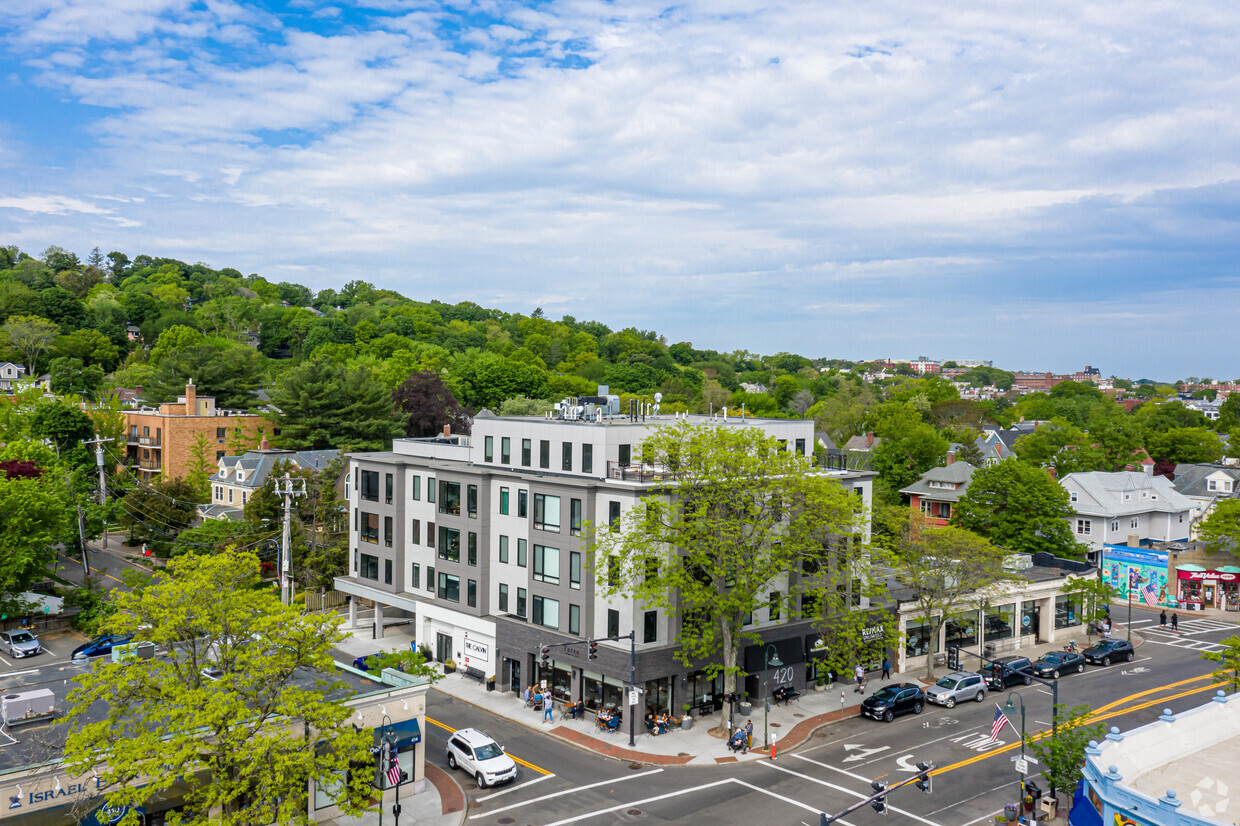 At a Bustling Corner with Complementing Businesses - The Calvin at Coolidge Corner