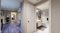This well-appointed single-floor residence offers four bedrooms, two bathrooms, a dining room, and a kitchen, all thoughtfully arranged across a comfortable and functional layout connected by two hallways. The living area features light hardwood-style flooring, crown molding, a ceiling fan, and large windows that invite natural light, creating a bright and welcoming atmosphere. The kitchen is outfitted with warm wood cabinetry, stainless steel appliances including a refrigerator, range, microwave, and dishwasher, as well as tile flooring and ample counter space. The dining room stands out with a tray ceiling, crown molding details, and a large mirror that enhances the sense of space. The primary bedroom is generously sized, featuring plush carpet, crown molding, a ceiling fan, and a window with outdoor views. Additional bedrooms are carpeted and trimmed with crown molding, offering comfortable and versatile spaces. Both bathrooms are finished with white tile flooring and white vanity cabinetry; one includes a bathtub and an extended double-sink vanity, while the other provides a clean, functional design. Neutral warm-toned walls throughout the residence contribute to a cohesive and inviting ambiance.