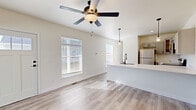 Located at 42 Manor Dr in Greenfield, Indiana, this well-designed 2-bedroom, 1-bathroom single-floor home offers a bright, modern interior with thoughtful finishes throughout. Light wood-look flooring runs seamlessly across the entire space, creating a cohesive and airy feel.

The open-concept kitchen and living area serves as the heart of the home. The kitchen features gray shaker-style cabinetry, a striking marble-look countertop, a large peninsula with pendant lighting overhead, and stainless steel appliances including a refrigerator, range, microwave, and dishwasher. A matte black faucet and undermount sink add a contemporary touch. Natural light pours into the adjacent living area through multiple windows fitted with blinds, complemented by a ceiling fan with a light fixture.

Both bedrooms are comfortably sized, each equipped with a ceiling fan and a double-door closet for ample storage. One bedroom features a large window with vertical blinds, while the other benefits from a high clerestory window that allows natural light while maintaining privacy.

The full bathroom offers gray cabinetry with black hardware, a marble-look vanity top, and a tub-shower combination. Additional spaces include a laundry area, utility room, and closets that contribute to efficient everyday living. The home's clean, neutral palette and modern fixtures make it a move-in ready residence.