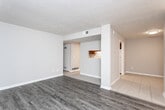 Located at 101 Waverly Way in Carrollton, Georgia, this single-story home offers four bedrooms and one bathroom across a well-organized floor plan. The layout includes a combined living and dining area, a dedicated hallway, two entrances, and a separate laundry room equipped with washer/dryer hookups and built-in overhead hanging rods.

The galley-style kitchen features warm wood cabinetry, white countertops, a gas range, and a refrigerator, all set over light tile flooring. The bathroom is finished with a full tub-shower combination and tile flooring in a clean, functional design.

The bedrooms offer a mix of flooring options — some feature dark hardwood-style laminate, while others are carpeted and include ceiling fans and natural light from multiple windows with blinds. The spacious primary bedroom includes a sliding glass door closet and a bright, windowed outlook. Additional bedrooms feature light tile floors and neutral wall tones, offering versatile use as sleeping quarters, offices, or flex spaces. A dedicated closet provides additional storage. The home's consistent use of neutral tones throughout creates a cohesive and practical living environment suitable for a variety of occupants.