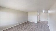 Located at 5912 Red Bluff Rd in Pasadena, TX, this single-story, one-bedroom, one-bathroom unit offers a practical and comfortable layout across a compact but well-utilized floor plan. The living room serves as the heart of the home, featuring durable wood-look laminate flooring, neutral gray-toned walls, a textured ceiling, and a large window that allows natural light to pour in while offering views of the surrounding outdoor greenery. The space flows into the kitchen, which is equipped with a coil-top electric range, a full-size refrigerator, and sage-toned upper cabinetry with an overhead ventilation hood. The bedroom is carpeted for warmth and comfort, fitted with a ceiling fan with light fixture, a window with outdoor views, and direct access to a dedicated closet with built-in shelving. The bathroom features a full tub-and-shower combination surrounded by warm beige tile, complemented by wood-look flooring. A hallway connects the rooms efficiently, and a dedicated laundry area adds everyday convenience. Throughout the unit, neutral tones, consistent finishes, and functional design create a clean and livable atmosphere well-suited for comfortable single-occupant living.