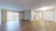 Located at 7085 W 130th St in Parma Heights, Ohio, this single-floor, 3-bedroom, 2-bathroom unit offers a well-organized layout designed for comfortable everyday living. Light wood-style flooring runs consistently throughout the space, lending a clean, cohesive look to every room.

The open living and dining area is generously sized, featuring a textured ceiling, neutral warm-toned walls, and a sliding glass door with vertical blinds that fills the space with natural light. This area flows seamlessly toward the kitchen and bedroom hallway, creating an intuitive and practical floor plan.

The kitchen is thoughtfully updated with white shaker-style cabinetry, white countertops, stainless steel appliances including a dishwasher, range, and microwave, recessed lighting, and a window above the sink for added natural light.

The three bedrooms are comfortably proportioned, each finished with the same light wood flooring and neutral walls. The primary bedroom is notably spacious, offering ample room for furnishings. Several bedrooms include closets with double doors for convenient storage. The hallways connecting the rooms are well-lit and open.

Both bathrooms are cleanly finished with wood-style flooring, light neutral walls, and chrome fixtures. One bathroom features a walk-in shower with a sliding glass enclosure, while the other includes a bathtub combination, white vanity cabinetry, and brushed nickel hardware.