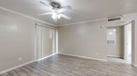Located at 1100 Langwick Dr in Houston, TX, this single-story, one-bedroom, one-bathroom unit offers a practical and well-appointed layout. Wood-look porcelain tile flooring runs throughout the entire space, providing a clean, cohesive aesthetic that is both stylish and easy to maintain.

The combined kitchen and living area forms the heart of the unit. The kitchen features white cabinetry, a marble-look countertop with a peninsula breakfast bar, stainless steel refrigerator, and a range, making efficient use of the available space. Crown molding and a ceiling fan with light fixture add a refined touch to the living area, which also benefits from a sliding glass door dressed with vertical blinds, allowing natural light to filter in.

The spacious primary bedroom is a standout feature, offering generous room for furnishings. It is finished with the same wood-look tile flooring, crown molding, a ceiling fan, and a sliding door with vertical blinds that brings in additional natural light. A dedicated closet provides ample storage.

The bathroom is clean and functional, equipped with a full tub-shower combination with white tile surround, a marble-look vanity countertop with a colorful vanity cabinet, and matching tile flooring. The unit is completed by a dedicated laundry area, adding everyday convenience to this well-organized Houston residence.