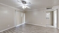 Located at 1100 Langwick Dr in Houston, TX, this single-story, one-bedroom, one-bathroom unit offers a practical and well-appointed layout. Wood-look porcelain tile flooring runs throughout the entire space, providing a clean, cohesive aesthetic that is both stylish and easy to maintain.

The combined kitchen and living area forms the heart of the unit. The kitchen features white cabinetry, a marble-look countertop with a peninsula breakfast bar, stainless steel refrigerator, and a range, making efficient use of the available space. Crown molding and a ceiling fan with light fixture add a refined touch to the living area, which also benefits from a sliding glass door dressed with vertical blinds, allowing natural light to filter in.

The spacious primary bedroom is a standout feature, offering generous room for furnishings. It is finished with the same wood-look tile flooring, crown molding, a ceiling fan, and a sliding door with vertical blinds that brings in additional natural light. A dedicated closet provides ample storage.

The bathroom is clean and functional, equipped with a full tub-shower combination with white tile surround, a marble-look vanity countertop with a colorful vanity cabinet, and matching tile flooring. The unit is completed by a dedicated laundry area, adding everyday convenience to this well-organized Houston residence.