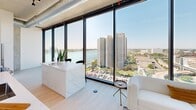Located on the 14th floor at 222 Third Street in the heart of Detroit, this one-bedroom, one-bathroom residence offers a thoughtfully designed layout with a clean, contemporary aesthetic throughout. The open living and kitchen area is anchored by dramatic floor-to-ceiling windows that flood the space with natural light and frame stunning panoramic views of the Detroit River and the city skyline — a defining feature of this urban retreat.

The kitchen is sleek and functional, outfitted with white flat-front cabinetry, a white quartz countertop, and a full suite of stainless steel appliances including a range, over-the-range microwave, and refrigerator. Light hardwood flooring carries through the main living areas, complementing the bright, neutral palette.

The bedroom is a serene haven, benefiting from its own floor-to-ceiling window showcasing the cityscape below. Exposed industrial ductwork and a concrete ceiling lend an urban loft character, while the generous proportions allow for comfortable furnishing.

The bathroom is spa-inspired, featuring large-format tile flooring, a frameless glass walk-in shower with white subway tile, and a long floating vanity with a white stone countertop and ample storage. A hallway and dedicated closet complete the layout, adding practical storage solutions. The overall ambiance is modern, airy, and distinctly metropolitan.