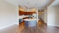 This contemporary 1310 square foot residence in Summit boasts a thoughtful layout with 3 bedrooms and 3 bathrooms. The open floor plan creates a seamless flow between living spaces, enhanced by large windows that flood the interior with natural light. The gourmet kitchen is a standout feature, showcasing rich wood cabinetry, stainless steel appliances, and a generous center island with granite countertops.

The living area is anchored by a sleek, modern fireplace and opens onto a balcony, offering picturesque views of the surrounding landscape. Hardwood flooring runs throughout the main living areas, while plush carpeting adds comfort to the bedrooms. The primary bedroom, measuring 200 square feet, provides ample space and includes an en-suite bathroom.

All three bathrooms are finished with high-quality fixtures, granite countertops, and a mix of tiled and wood-look flooring. The home's design incorporates practical elements such as closet space and hallways for easy navigation. Ceiling fans and recessed lighting contribute to the overall modern aesthetic while enhancing comfort and functionality. This well-appointed home strikes a perfect balance between style and livability, making it an ideal choice for those seeking a contemporary living space.