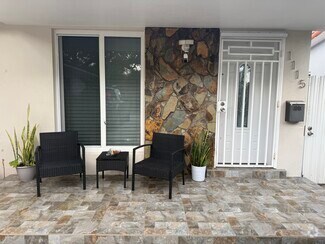 Front part of the house with a private gated entrance to backyard - 1115 NW 32nd Ave