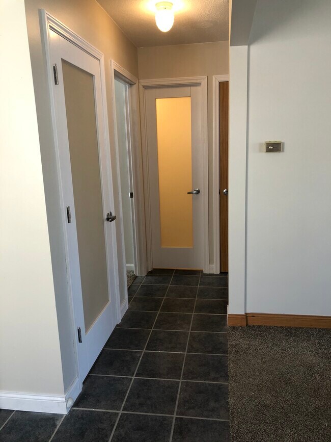 Hallway - beautiful new frosted doors for bathroom and basement - 1966 Maryland Ave E