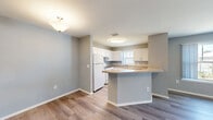 Located at 532 Park Tree Terrace in Orlando, FL, this two-story residence offers 3 bedrooms, 3 bathrooms, and two dedicated closets across a well-organized floor plan. The main living level centers around an open-concept kitchen and living area finished with durable wood-look flooring and neutral gray walls. The kitchen features white shaker-style cabinetry, a gas range, refrigerator, stainless steel sink, and a peninsula counter that serves as a natural divider between the cooking and living spaces, allowing for an easy flow between the two areas. A carpeted staircase connects the lower entry level to the upper floor, where the majority of the living space resides. Each of the three bedrooms offers a calm, neutral palette with light gray walls; the primary bedroom includes a walk-in closet with wire shelving for organized storage. The bedrooms are finished with plush carpet, and ceiling fans provide additional comfort. The bathrooms are clean and functional, featuring white vanity cabinetry and tiled shower/tub combinations with wood-look flooring. Two additional closets throughout the home offer practical storage solutions. The overall design is consistent and understated, making for a move-in-ready space in a convenient Orlando location.