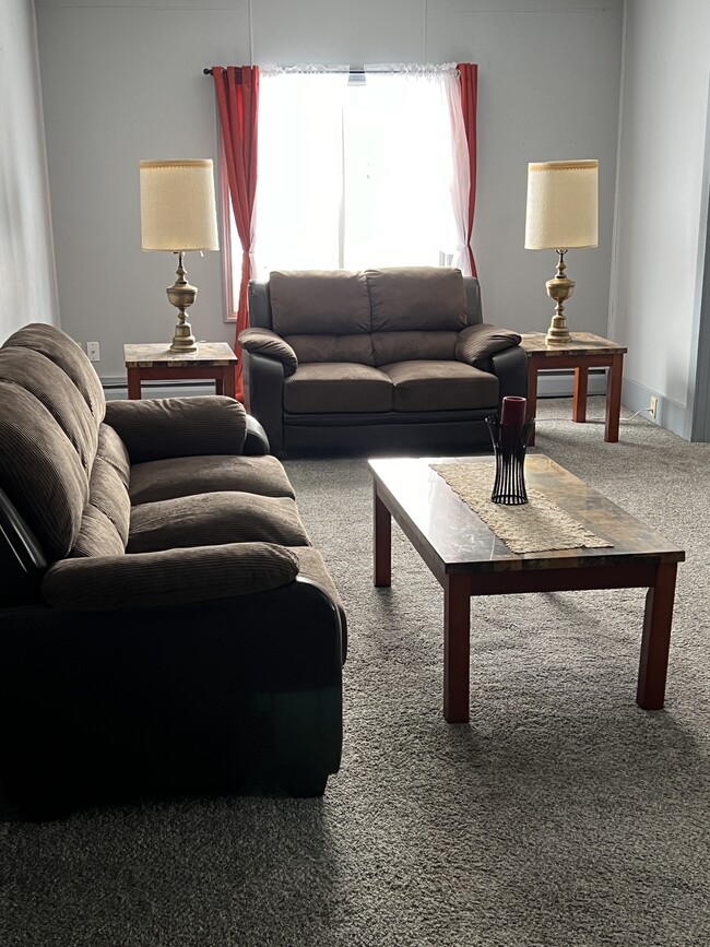 Includes couch, loveseat, chair, end tables, coffee table and lighting - 802 Main St