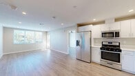 This contemporary 2-bedroom, 2-bathroom apartment in San Diego offers 800 square feet of thoughtfully designed living space. The open floor plan creates a seamless flow between the living areas, enhancing the sense of spaciousness. Light wood-toned flooring runs throughout, complementing the neutral wall colors and creating a bright, airy atmosphere.

The kitchen is a highlight, featuring sleek white cabinetry, stainless steel appliances, and ample counter space. It opens directly to the living area, perfect for entertaining. Large windows in the living room and bedrooms flood the space with natural light and offer pleasant views of the surrounding area.

The primary bedroom, measuring 170 square feet, provides a generous retreat. Both bathrooms are modern and functional, with one featuring a glass-enclosed shower. Recessed lighting throughout and ceiling fans in the bedrooms add to the overall comfort and style.

Additional features include in-unit laundry facilities and custom window treatments. This apartment combines modern design with practical living, making it an ideal urban residence in the desirable 92107 zip code of San Diego.