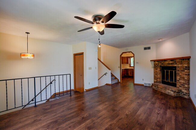 Sunny living room with LVP, wood fireplace - 832 Walnut St