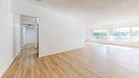 Located at 488 W Duarte Rd in Arcadia, CA, this well-appointed 3-bedroom, 3-bathroom single-floor residence offers a thoughtfully designed layout with generous living space throughout. Light wood flooring flows seamlessly across every room, creating a warm and cohesive aesthetic complemented by crisp white walls and textured ceilings.

The open living and dining area is a standout feature, anchored by a striking white-painted brick fireplace that serves as a bold focal point. Large windows flood the space with abundant natural light and offer pleasant views of surrounding greenery. A pendant chandelier adds a finishing touch to the dining area.

The galley-style kitchen is efficiently designed with ample white cabinetry, granite-toned countertops, stainless steel appliances, and overhead flush-mount lighting, providing both style and functionality.

Each of the three bedrooms is well-sized, featuring built-in closets and ceiling fans. The spacious primary bedroom enjoys direct access to a private balcony through a sliding glass door, bringing in natural light and outdoor views. The bathrooms are finished consistently with wood-look flooring, granite vanity countertops, and clean white cabinetry. The space also includes six closets and a hallway, ensuring ample storage throughout.
