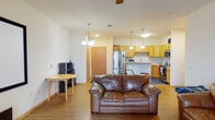 Located at 734 Jupiter Dr in Madison, WI, this single-floor unit offers a practical and comfortable layout designed for everyday living. The open-concept living and dining area is anchored by warm hardwood-style flooring, a ceiling fan, and a sliding glass door that leads to a private balcony, allowing natural light to fill the space. A dining nook sits adjacent to the living area, creating a seamless flow throughout the common spaces.

The kitchen is well-appointed with warm-toned oak cabinetry, a classic white subway tile backsplash, and a full suite of stainless steel appliances including a French door refrigerator, dishwasher, microwave, and range. Ample counter space and abundant cabinet storage make this kitchen highly functional.

The bedroom offers a cozy, carpeted retreat with a generously sized window fitted with blinds, providing both natural light and privacy. The room comfortably accommodates a full-sized bed and additional furnishings.

The bathroom features oak cabinetry with a white countertop vanity and neutral tile flooring, maintaining the warm, cohesive aesthetic found throughout the unit. Warm wood-tone interior doors are consistent across all rooms, contributing to the unit's unified and inviting character.