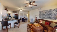 This single-story, 2-bedroom, 1-bathroom residence in Owasso, Oklahoma offers a thoughtfully arranged floor plan that maximizes its compact footprint. The open-concept living area greets residents upon entry, featuring carpet flooring, a ceiling fan with light fixture, and a large window that fills the space with natural light. The layout flows naturally into the kitchen and dining area, where vaulted ceilings add a sense of height and openness. The kitchen is equipped with black appliances, white cabinetry, dark countertops, tile flooring, and a breakfast bar with seating. A dedicated dining area adjacent to the kitchen provides additional space for meals.

The primary bedroom includes a ceiling fan, a walk-in closet, and a window with outdoor views, while the second bedroom also features a ceiling fan and carpeted floors. The full bathroom includes a tub and shower combination with sliding glass doors. A dedicated laundry area accommodates a full-sized washer and dryer with wire shelving above. A hallway connects the private areas of the residence, completing a functional and well-organized layout throughout.