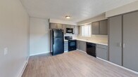Located at 2005 NE Terre View Dr in Pullman, WA, this one-bedroom, one-bathroom unit offers a practical and efficiently arranged single-floor layout. The open living area features light wood-style flooring and neutral gray walls, creating a clean and versatile space. A baseboard heating system runs along the living area wall, ensuring year-round comfort. The kitchen is well-equipped with gray cabinetry, a full suite of black appliances including a refrigerator, electric range, built-in microwave, and dishwasher, along with a window that brings in natural light. Light wood-style flooring continues throughout the kitchen and living areas, providing a cohesive look. The bedroom offers comfortable carpeted flooring, a window with blinds overlooking the outdoors, and a baseboard heater. Neutral-toned walls and a textured ceiling are consistent throughout the unit. The bathroom features wood-style flooring, a white vanity with storage, a mirror, and convenient in-unit stacked washer and dryer — a notable practical feature. The overall design is straightforward and functional, making this an ideal space for those seeking low-maintenance living in the Pullman area.
