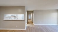 Located at 1357 Sharon Road West in Charlotte, NC, this single-floor, 3-bedroom, 2-bathroom home offers a well-organized and functional layout. The combined living and dining area serves as the heart of the home, finished with light wood-look flooring and neutral warm-gray walls throughout. A textured ceiling adds subtle character, while a sliding glass door floods the living space with natural light and provides direct access to an outdoor area.

The kitchen connects seamlessly to the main living space via a pass-through counter with a light-toned surface, housing white appliances and a stainless steel sink — an efficient and practical setup for everyday use.

A central hallway links the living area to the private quarters, where three bedrooms offer comfortable accommodations. The spacious primary bedroom features plush carpeting and double closet doors, providing generous storage. The additional bedrooms are similarly carpeted with individual closets and windows that allow in natural light.

Both bathrooms are fitted with full tub-shower combinations with clean white surrounds and updated fixtures. A dedicated laundry area with washer hookups and overhead shelving adds everyday convenience. Four closets throughout provide ample storage across the home.