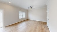 Located at 102 Whistle Stop Cir in Lenoir City, Tennessee, this single-floor, one-bedroom, one-bathroom home offers a well-designed layout with modern finishes throughout. Light-toned hardwood flooring flows consistently across every room, creating a cohesive and inviting atmosphere.

The kitchen is a standout feature, boasting white shaker cabinetry reaching to the ceiling, granite countertops, a central island with a sink and pendant lighting above, a striking hexagonal tile backsplash, and a full suite of stainless steel appliances — including a refrigerator, range, and over-the-range microwave. Crown molding and recessed lighting add a refined touch to the space.

The living area is bright and open, featuring a ceiling fan, natural light from a window with blinds, and clean neutral walls that complement the overall aesthetic. The spacious bedroom includes its own ceiling fan, a window overlooking the exterior, and direct access to a walk-in closet equipped with wire shelving for ample storage.

The bathroom features a clean, all-white walk-in shower with brushed nickel fixtures, complemented by the same warm hardwood flooring seen throughout the home. A hallway connects the rooms efficiently, and the layout reflects a thoughtful, functional design well-suited for comfortable everyday living.