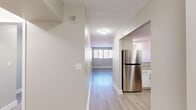 Located at 600 Main Street in Worcester, MA, this 1-bedroom, 1-bathroom residence offers a clean, modern design across a single thoughtfully arranged floor. Light wood-style flooring flows throughout the main living areas, complemented by neutral wall tones that create a bright, cohesive atmosphere.

The hallway entry provides a welcoming introduction to the space, leading to an open living room bathed in natural light. The living area features track lighting and a pass-through connection to the kitchen, enhancing the sense of openness.

The kitchen is a standout feature, outfitted with crisp white shaker-style cabinetry, granite-look countertops, and a full suite of stainless steel appliances including a refrigerator, electric range, built-in microwave, and dishwasher — ideal for both everyday cooking and entertaining.

The bedroom is a comfortable retreat, carpeted for warmth and quiet, with a large window overlooking the surrounding streetscape and a double-door closet providing ample storage.

The bathroom is finished with a white vanity, granite-style countertop, a large mirror, and a shower/tub combination, maintaining the clean aesthetic found throughout. Two hallways connect the rooms efficiently, adding to the unit's functional flow.