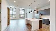 Located at 9901 Metcalf Ave in Overland Park, KS, this two-story residence offers three bedrooms, three full bathrooms, and three closets across a well-designed floor plan. The main level provides the majority of the living space and centers around an open-concept kitchen and living room. The kitchen is a standout feature, boasting rich dark-wood cabinetry, stainless steel appliances, a large white quartz island with pendant lighting, and wood-look flooring that flows throughout the main level. The living room is anchored by soaring ceilings and dramatic floor-to-ceiling black-framed windows that flood the space with natural light and offer open views of the surrounding Overland Park area. The upper level houses additional bedrooms, including a generously sized primary bedroom. Bedrooms are finished with plush carpeting and ceiling fans, with windows providing natural light and outdoor views. Each bathroom is appointed with dark-wood vanities, white countertops, and stylish light fixtures, maintaining a consistent modern aesthetic. The walk-in closets feature built-in shelving and hanging rods, maximizing storage efficiency. Clean white walls, neutral tones, and contemporary finishes throughout give the residence a bright, cohesive, and move-in-ready character.