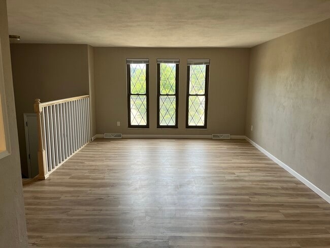 Living Room with new flooring and fresh paint. - 608 Sangree Rd House