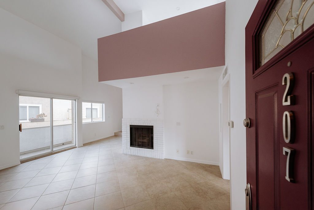 Entry, living area, fireplace, loft overhang - 3651 Jasmine Ave