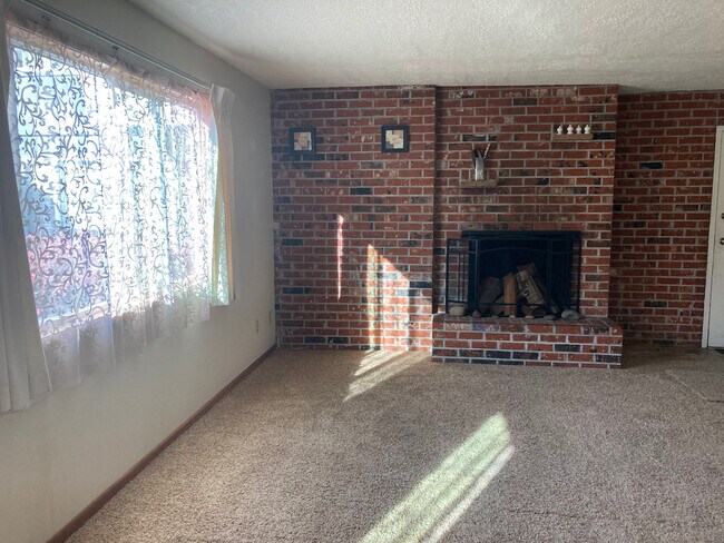 Living Room Fireplace and Window with Pool View - 6404 SE Division St