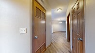 Located at 2704 Westmar Ct in Toledo, Ohio, this two-story home offers a practical and well-organized layout across two floors. The main level features an open-concept living room, dining area, and kitchen combination, creating a connected and functional shared living space. The kitchen is equipped with warm oak cabinetry, white countertops, a double-basin sink beneath a window, and a dishwasher, all set on durable wood-style vinyl flooring that carries throughout the main level. A half bathroom on this floor adds convenience, and a staircase with wood-trimmed railings leads to the upper level. Upstairs, three carpeted bedrooms provide comfortable retreats, including a generously sized primary bedroom with a ceiling fan and a large window that invites natural light. Bedrooms feature wood-paneled closet doors, and at least one room includes a spacious walk-in closet outfitted with wire shelving. Two full bathrooms serve the upper floor, each with wood-tone doors and tub-shower combinations. A dedicated laundry room adds everyday practicality. Throughout the home, warm wood trim and neutral wall tones create a cohesive, understated aesthetic. With multiple closets and a well-distributed floor plan, this home offers solid functionality for a range of living needs.