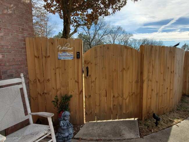 Access unit through wooden gate in back yard fence. - 4503 S Shades Crest Rd