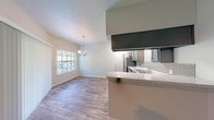 Located at 623 Hill City Dr in Duncanville, TX, this single-story residence offers a thoughtfully designed open-concept layout that seamlessly connects the main living areas. The living room is a welcoming focal point, anchored by a tile-surround fireplace and large windows that fill the space with natural light. Wood-look laminate flooring flows throughout the main living areas, adding warmth and visual continuity.

The kitchen is well-appointed with slate-blue cabinetry, granite-style countertops, a subway tile backsplash, and a full suite of stainless steel appliances including a refrigerator and dishwasher. A breakfast bar with an overhang provides convenient casual seating and connects directly to the adjacent dining area, which is accented by a hanging chandelier.

The bedrooms feature plush carpeting, ceiling fans with light fixtures, and windows with blinds that provide natural light and privacy. The bathrooms are finished with matching slate-blue cabinetry, granite-style countertops, and wood-look flooring, maintaining a consistent design palette throughout. A walk-in closet is accessible from one of the bathrooms, offering generous storage. A dedicated laundry area with washer and dryer hookups adds practical functionality to this well-appointed home.