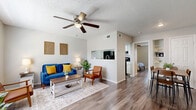 This one-bedroom, one-bathroom residence in Leon Valley, Texas offers a thoughtfully designed single-floor layout that maximizes every square foot. Wood-look flooring flows throughout the main living areas, creating a cohesive and modern aesthetic. The open living room is bright and welcoming, featuring a ceiling fan with light fixture, a textured ceiling, and a large window that allows natural light to fill the space. A pass-through window connects the living area to the kitchen, enhancing the sense of openness. The kitchen is efficiently equipped and includes access to a pantry for additional storage. An adjacent dining area provides a dedicated space for meals. The bedroom is a comfortable retreat, featuring its own ceiling fan, wood-look flooring, a natural light-admitting window, and two closets for generous storage. The bathroom includes a full-size soaking tub and shower combination with clean white tile surround. Throughout the unit, neutral wall tones complement the warm flooring, contributing to a calm and cohesive ambiance. Two closets provide practical storage solutions. Located at 5900 Wurzbach Rd, this unit offers convenient access to the amenities of the Leon Valley and greater San Antonio area.