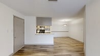 Located in Union City, GA, this well-designed single-story home offers three bedrooms, two bathrooms, and a functional layout across a comfortable footprint. The open-concept living and kitchen area serves as the heart of the home, featuring light wood-look plank flooring, a textured ceiling, and a pendant light fixture that adds a welcoming touch. The kitchen is equipped with stainless steel appliances, a gas range, a mosaic tile backsplash, gray cabinetry, and a peninsula with a built-in sink and light countertops — ideal for both cooking and casual dining. A sliding glass door in the living area allows natural light to fill the space and provides outdoor access, complemented by a ceiling fan overhead. The three bedrooms are carpeted for comfort, with the spacious primary bedroom offering generous square footage. A walk-in closet with wire shelving provides ample storage. The two bathrooms feature wood-look tile flooring, gray vanity cabinetry, and a shower-tub combination. A hallway connects the bedrooms and bathrooms, creating a private and organized layout. Clean white walls and neutral finishes throughout lend the home a bright, move-in-ready aesthetic.