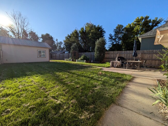 Back patio and yard with garden beds - 748 Alta Vista St
