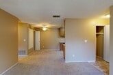 Located in Fair Oaks, CA, this single-story, 2-bedroom, 2-bathroom unit offers a practical and comfortable layout designed for everyday living. The open living area features wall-to-wall carpet, neutral tan walls, a textured ceiling, and a ceiling fan, creating a warm and functional space. Adjacent to the living area, the kitchen is well-equipped with oak cabinetry, light speckled countertops, a gas range, dishwasher, refrigerator, and a sink — all set on tile flooring that contrasts with the carpeted main areas. Both bedrooms are carpeted and receive natural light through sliding windows with outdoor views of the surrounding property. The spacious primary bedroom includes a generous walk-in closet with wrap-around shelving and hanging rods. The two bathrooms feature tile flooring, oak vanities with speckled countertops, and a tub-shower combo. One bathroom conveniently houses a stacked washer and dryer unit. The layout flows efficiently, connecting all rooms through a central hallway. Overall, the unit presents a clean, move-in ready interior with consistent finishes throughout.