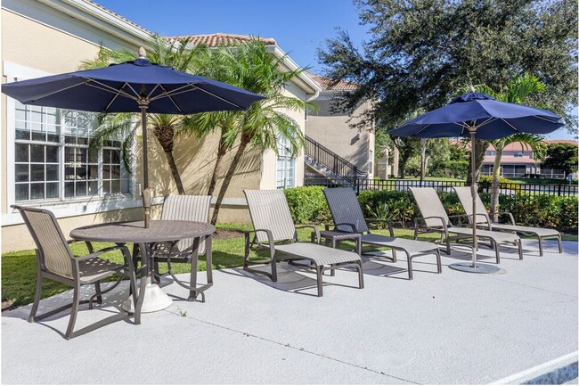 Poolside dining and lounge chairs - Cypress Legends