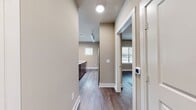 This contemporary 950 square foot apartment offers a well-designed living space with two bedrooms and two bathrooms. The open-concept layout seamlessly integrates the kitchen, dining, and living areas, creating a spacious feel. The gourmet kitchen is a standout feature, boasting dark wood cabinetry, stainless steel appliances, and a large island with a granite countertop and undermount sink.

Both bedrooms are generously sized, with the primary bedroom measuring 170 square feet. Each room features large windows with blinds, allowing for abundant natural light and outdoor views. The bathrooms are modern and sleek, with floating vanities, vessel sinks, and stylish fixtures. One bathroom includes a combination tub-shower, while the other offers a walk-in shower.

Throughout the apartment, you'll find high-quality finishes such as wood-look vinyl flooring, recessed lighting, and ceiling fans. The neutral color palette provides a blank canvas for personalization. Ample closet space, including walk-in closets with built-in shelving systems, offers plenty of storage options.

This single-floor unit, located in the Savoye complex (Two Bedroom, B2F, 1-101), combines contemporary design with practical living, making it an ideal home for those seeking modern comfort and style.